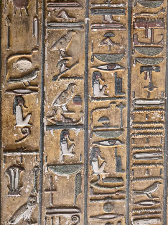 Painted hieroglyphs in columns on a tomb wall